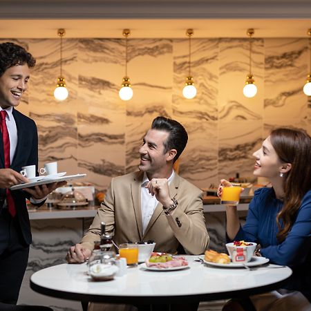 La Clef Champs-Elysees Paris By The Crest Collection Kültér fotó A butler serving guests at the lounge